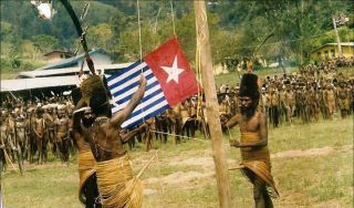 Morning Star flag being raised by Yali tribesman (supplied)